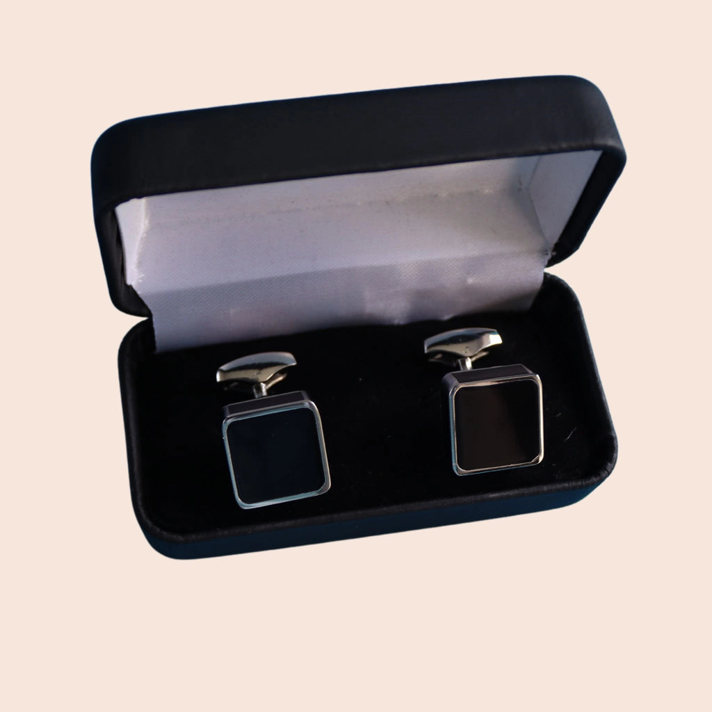 black cube cufflinks with silver coloured mount in presentation box